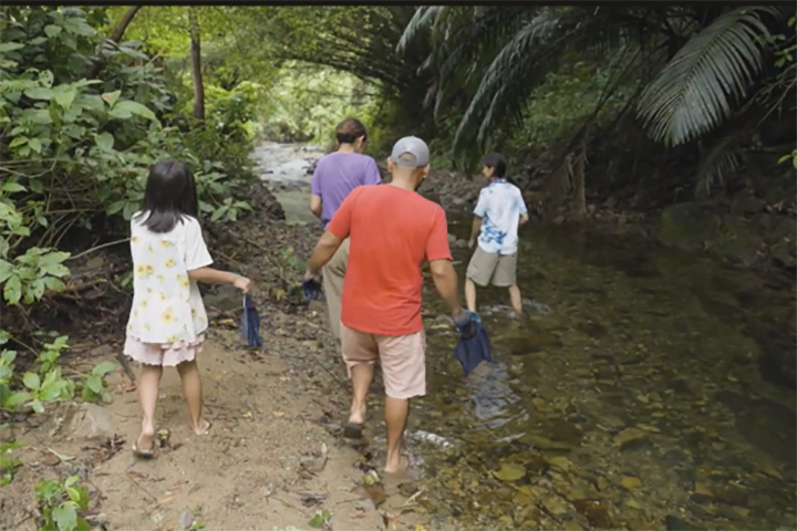 みんなで川に入って藍染め液を洗い流す