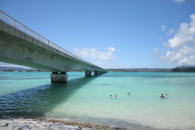 人気スポット古宇利ビーチ。古宇利島の入口にあるエメラルド色の海